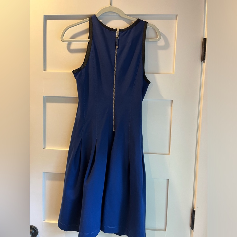 Blue knee length cocktail dress with pleats around waist.